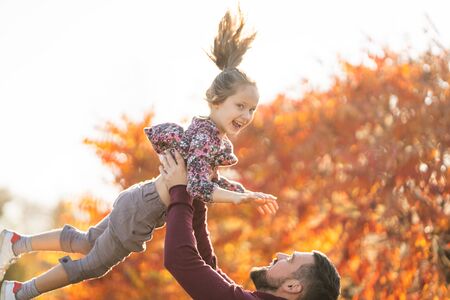 dad with his daughter in the autumn park walksの写真素材