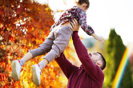 dad with his daughter in the autumn park walksの写真素材