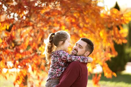 dad with his daughter in the autumn park walksの写真素材