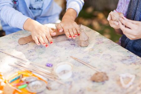 children make clay figures by potteryの写真素材