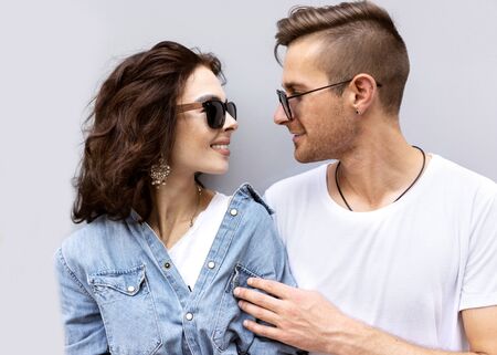 fashion couple posing on a gray background in the streetの写真素材