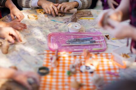 children make clay figures by potteryの写真素材