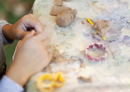 children make clay figures by potteryの写真素材