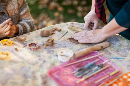 children make clay figures by potteryの写真素材