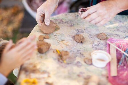 children make clay figures by potteryの写真素材