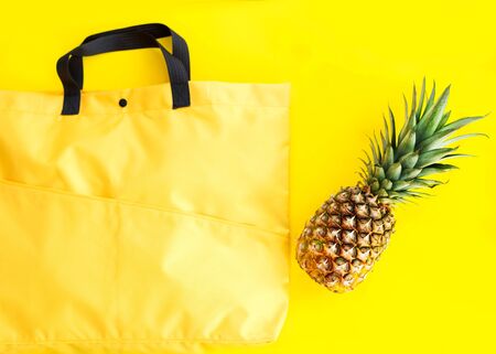 shopping bag with pineapple on the yellow background, delivery, takeawayの写真素材