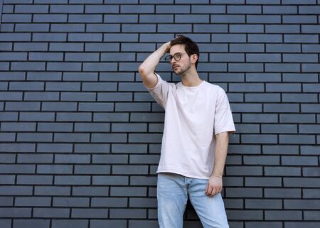 fashion guy  poses brick black urban backgroundの写真素材
