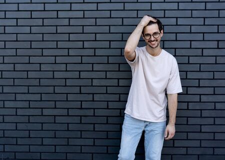 fashion guy  poses brick black urban backgroundの写真素材