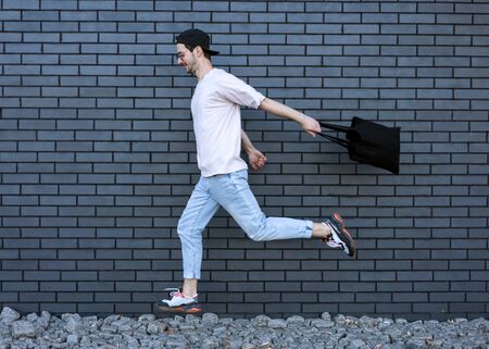 fashion guy run over brick black urban backgroundの写真素材