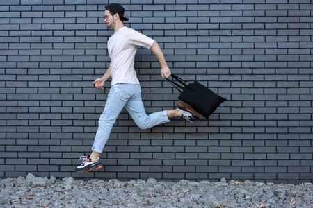 fashion guy run over brick black urban backgroundの写真素材