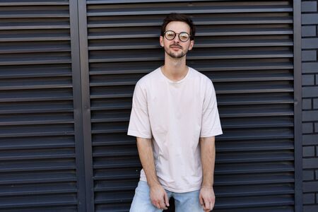 fashion guy  poses brick black urban backgroundの写真素材