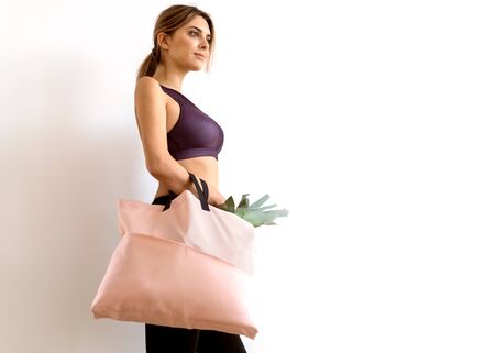 girl with a shopping bag in pink hands with
products. Take away, fitness food.の写真素材
