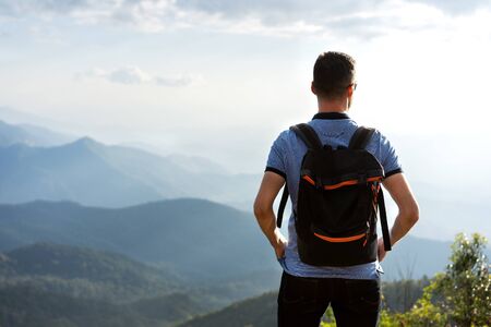 tourist guy stands on the edge of the mountains in thailandの写真素材