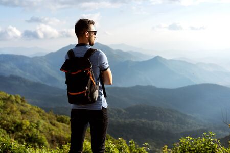 tourist guy stands on the edge of the mountains in thailandの写真素材