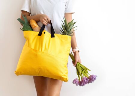 girl holding a bag with products with takeaway food. Food deliveryの写真素材