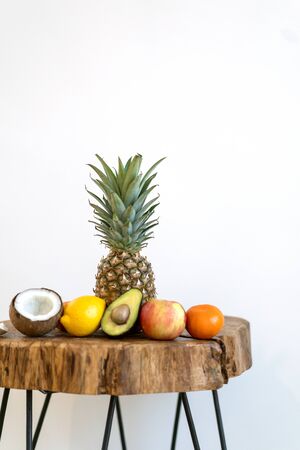 tropical fruits lie on a table on a white backgroundの写真素材