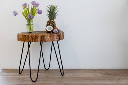 on a beautiful table handmade loft stands a bouquet of tulip flowers in interiorの写真素材