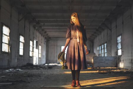 fashion girl in a dress in hands holding a pyrotivgas in handing over a virus infectedの写真素材