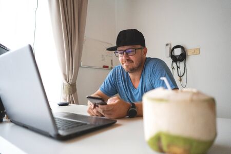 freelancer guy with laptop  working at home in quarantine to coronavirus infectionの写真素材