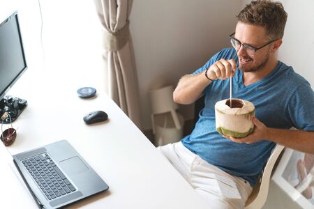 freelancer guy with laptop working at home in quarantine to coronavirus infection
