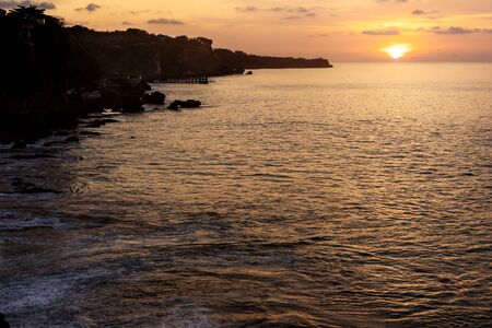 beautiful golden sunset on the island of baliの写真素材