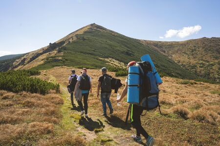 Hikers goes to the mountains on a sunset hike. Ecotourism.の写真素材