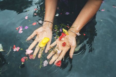 girl's hands on bali holy springsの写真素材