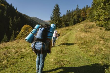 Hikers goes to the mountains on a sunset hike. Ecotourism.の写真素材