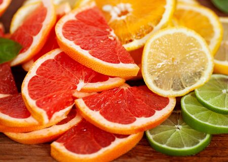 Slices of mandarin, orange, grapefruit and lemon very close-up, macroの写真素材