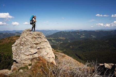 Hiker goes to the mountains on a sunset hike. Ecotourism.の写真素材
