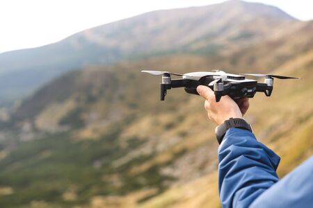 guy tourist holding a drone in the mountainsの写真素材
