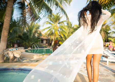 girl posing in palm leaves on an islandの写真素材