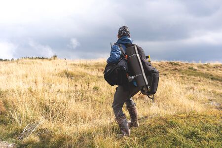 hiker in the mountains with backpacksの写真素材