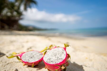 dragon fruit lies on a stove by the seaの写真素材