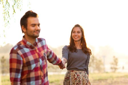 couple in love walks at sunset in the sunの写真素材