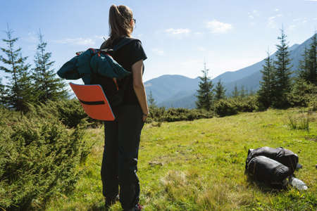 Hikers goes to the mountains on a sunset hike. Ecotourism.