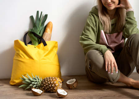 Bag with groceries, fruits and herbs, on the floor. Deliveryの写真素材