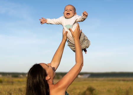 mom and son in a beautiful field are played, freedom concept