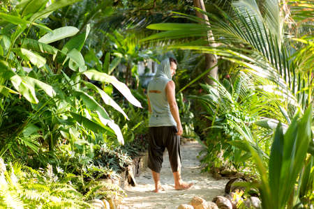 fashion guy on the beach at sunset in jungleの写真素材