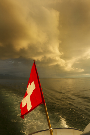 Switzerland  Swiss flag on boat  Lake Lemanの写真素材