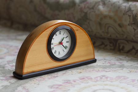 Old wooden clock on the table 
