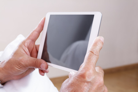 Senior man using digital tabletの写真素材