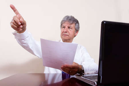 Businessman working with laptop in a interior office.