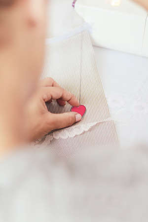 Young woman sewing a heartの写真素材