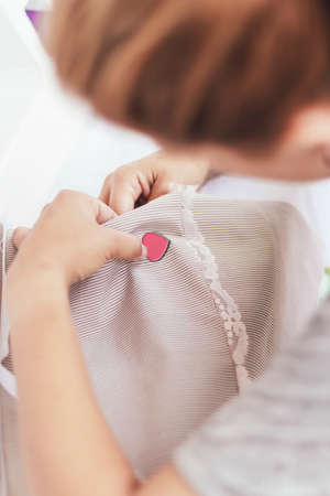 Young woman sewing a heartの写真素材