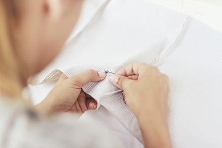 Young woman sewing a handbagの写真素材