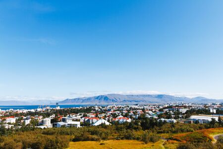 Aerial view of Reykjavik, Iceland with harbor and skyline mountainsの写真素材