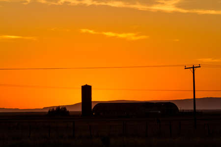 Iceland sunset with a silhouette farmの写真素材