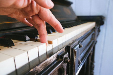 Hand touching the pianoの写真素材