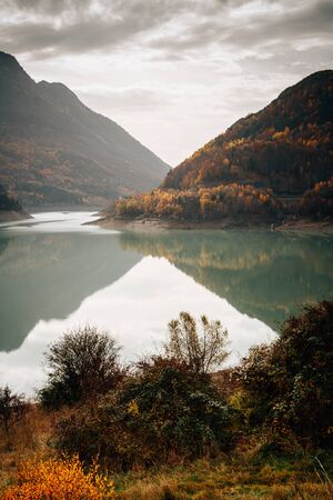 Autumn view of a forest reflecting in a lake